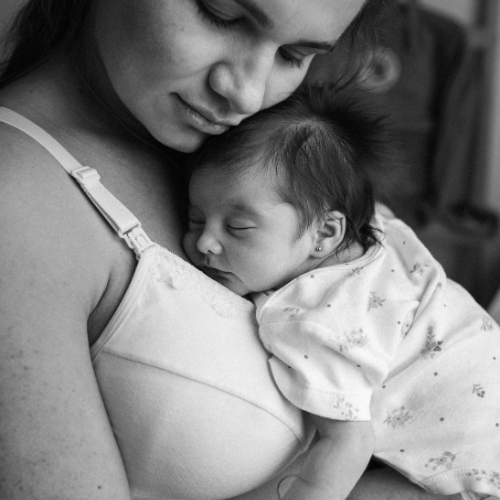 mom holding newborn close to chest